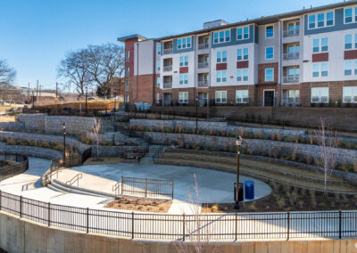 sunny view of terraced outdoor area surrounded by apartment buildings at The View at NoDA in Athens Georgia
