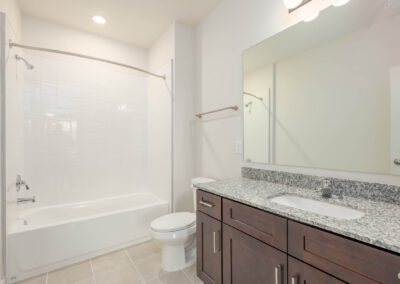 residence bathroom with vanity, toilet, and bathtub